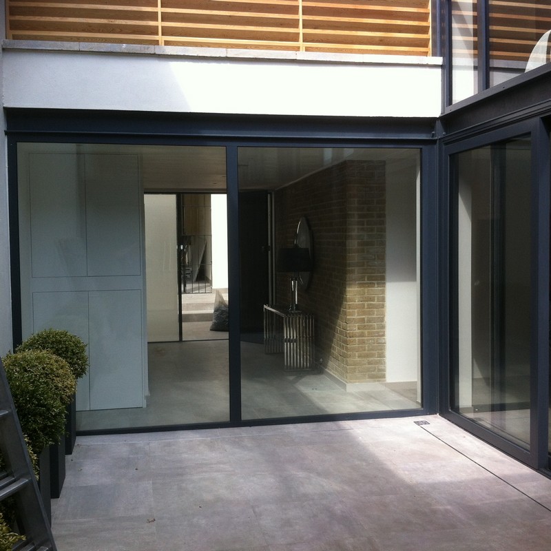Floor-to-ceiling sliding doors opening to courtyard in Hatfield