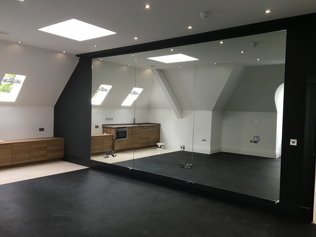 Frameless glass wall dividing loft conversion in Hatfield